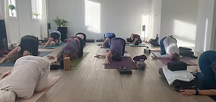 Students resting in child’s pose during a class in the Reset studio